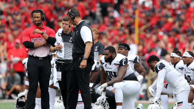 Cincinnati Bearcats defensive coordinator Marcus Freeman, left, stands next to head coach Luke Fickell during an injury timeout of a college football game against the Ohio State Buckeyes, Saturday, Sept. 7, 2019, at Ohio Stadium in Columbus. Cincinnati Bearcats At Ohio State Buckeyes Sept 7