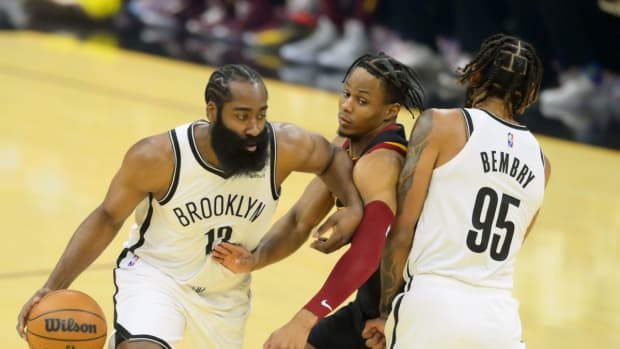 Nov 22, 2021; Cleveland, Ohio, USA; Cleveland Cavaliers guard Darius Garland (10) defends Brooklyn Nets guard James Harden (13) and guard DeAndre' Bembry (95) in the first quarter at Rocket Mortgage FieldHouse. Mandatory Credit: David Richard-USA TODAY Sports