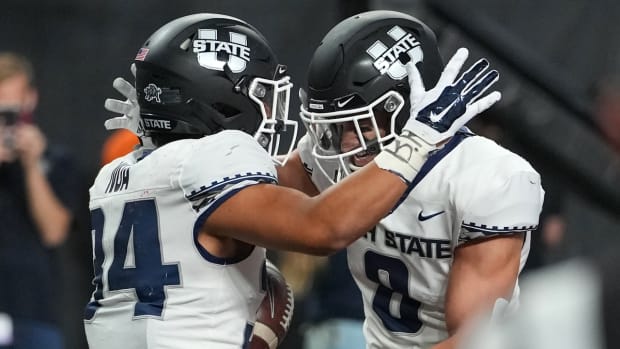 Oct 16, 2021; Paradise, Nevada, USA; Utah State Aggies running back Elelyon Noa (34) celebrates with Utah State Aggies wide receiver Derek Wright (8) after scoring the game-winning touchdown against the UNLV Rebels at Allegiant Stadium. Mandatory Credit: Stephen R. Sylvanie-USA TODAY Sports