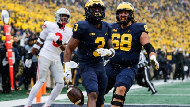 Michigan receiver A.J. Henning (3) celebrates with offensive lineman Andrew Vastardis (68) after scoring a touchdown and during the first quarter against Ohio State at Michigan Stadium in Ann Arbor on Saturday, Nov. 27, 2021. 2021-11-27-ohio-state-michigan