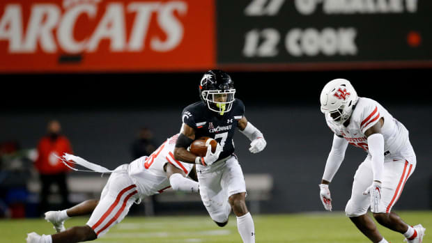 Cincinnati Bearcats wide receiver Tre Tucker (7) runs with a catch in the third quarter of the American Athletic Conference football game between the University of Houston Cougars and the University of Cincinnati Bearcats at Nippert Stadium in Cincinnati on Saturday, Nov. 7, 2020. The Bearcats continued their undefeated campaign with a 38-10 win over Houston. Houston Cougars At Cincinnati Bearcats Football