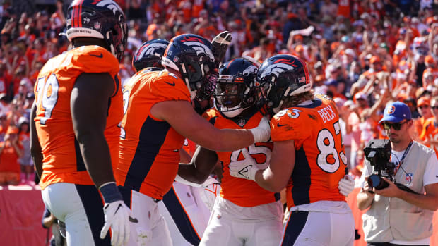 Denver Broncos running back Melvin Gordon (25) celebrates his rushing touchdown with tight end Andrew Beck (83) and offensive tackle Garett Bolles (72) in the second quarter against the New York Jets at Empower Field at Mile High.