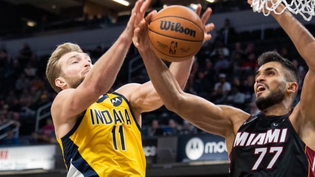 Dec 3, 2021; Indianapolis, Indiana, USA; Indiana Pacers forward Domantas Sabonis (11) and Miami Heat center Omer Yurtseven (77) fight for a rebound in the second half at Gainbridge Fieldhouse. Mandatory Credit: Trevor Ruszkowski-USA TODAY Sports