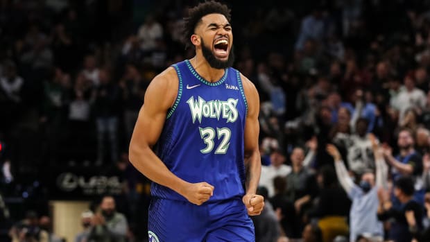 Minnesota Timberwolves center Karl-Anthony Towns (32) celebrates after making a three-point shot against the Phoenix Suns.