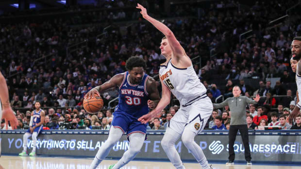 New York Knicks forward Julius Randle (30) looks to drive past Denver Nuggets center Nikola Jokic (15) in the third quarter at Madison Square Garden.