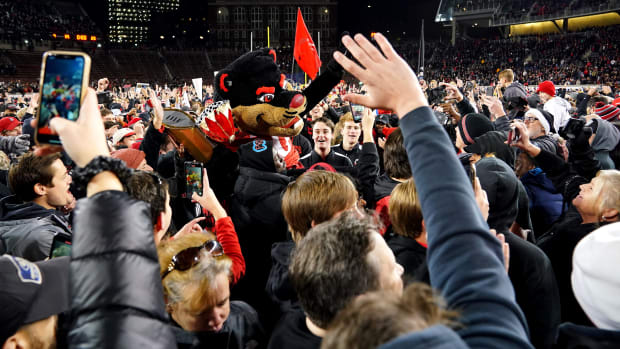 Cincinnati Bearcats fans celebrate on the field at the conclusion of the American Athletic Conference championship football game, Saturday, Dec. 4, 2021, at Nippert Stadium in Cincinnati. The Cincinnati Bearcats defeated the Houston Cougars, 35-20. Houston Cougars At Cincinnati Bearcats Aac Championship Dec 4
