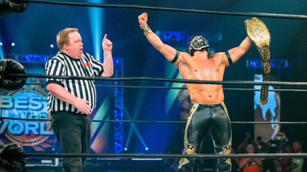 Bandido celebrates with the Ring of Honor championship