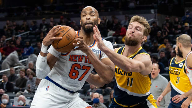 Dec 8, 2021; Indianapolis, Indiana, USA; New York Knicks center Taj Gibson (67) rebounds the ball in front of Indiana Pacers forward Domantas Sabonis (11) in the second half at Gainbridge Fieldhouse. Mandatory Credit: Trevor Ruszkowski-USA TODAY Sports