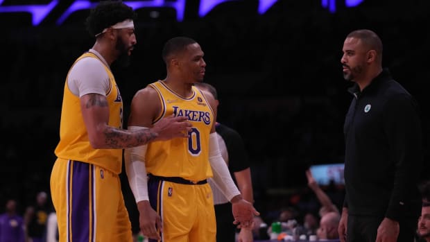 Dec 7, 2021; Los Angeles, California, USA; Los Angeles Lakers forward Anthony Davis (3) and guard Russell Westbrook (0) confront Boston Celtics coach Ime Udoka in the second half at Staples Center.The Lakers defeated the Celtics 117-102. Mandatory Credit: Kirby Lee-USA TODAY Sports