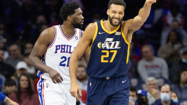 Dec 9, 2021; Philadelphia, Pennsylvania, USA; Utah Jazz center Rudy Gobert (27) reacts in front of Philadelphia 76ers center Joel Embiid (21) after losing control of the ball during the first quarter at Wells Fargo Center. Mandatory Credit: Bill Streicher-USA TODAY Sports