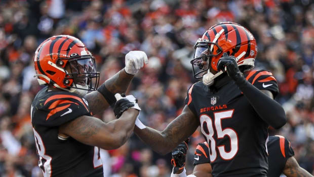 Dec 5, 2021; Cincinnati, Ohio, USA; Cincinnati Bengals running back Joe Mixon (28) celebrates after scoring a touchdown with wide receiver Tee Higgins (85) in the second half against the Los Angeles Chargers at Paul Brown Stadium. Mandatory Credit: Katie Stratman-USA TODAY Sports