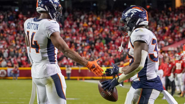 Dec 5, 2021; Kansas City, Missouri, USA; Denver Broncos running back Javonte Williams (33) celebrates with wide receiver Courtland Sutton (14) after scoring against the Kansas City Chiefs during the second half at GEHA Field at Arrowhead Stadium. Mandatory Credit: Denny Medley-USA TODAY Sports