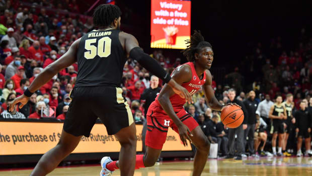 Dec 9, 2021; Piscataway, New Jersey, USA; Rutgers Scarlet Knights center Clifford Omoruyi (11) dribbles the ball against Purdue Boilermakers forward Trevion Williams (50) during the second half at Jersey Mike's Arena. Mandatory Credit: Catalina Fragoso-USA TODAY Sports