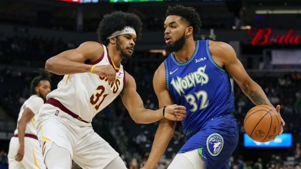 Dec 10, 2021; Minneapolis, Minnesota, USA; Minnesota Timberwolves center Karl-Anthony Towns (32) controls the ball as Cleveland Cavaliers center Jarrett Allen (31) defends during the first quarter at Target Center. Mandatory Credit: Nick Wosika-USA TODAY Sports


