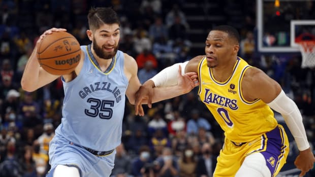 Dec 9, 2021; Memphis, Tennessee, USA; Memphis Grizzles forward Killian Tillie (35) drives to the basket as Los Angeles Lakers guard Russell Westbrook (0) defends during the second half at FedExForum. Mandatory Credit: Petre Thomas-USA TODAY Sports