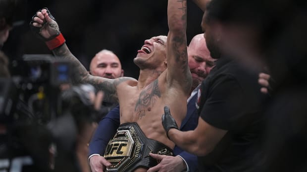 Charles Oliveira celebrates his victory by submission against Dustin Poirier.