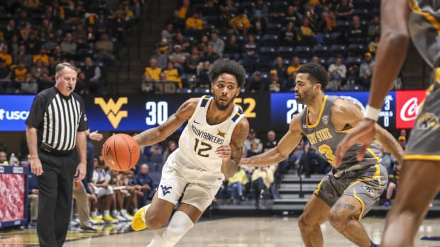 Dec 12, 2021; Morgantown, West Virginia, USA; West Virginia Mountaineers guard Taz Sherman (12) drives against Kent State Golden Flashes guard Sincere Carry (3) during the second half at WVU Coliseum.