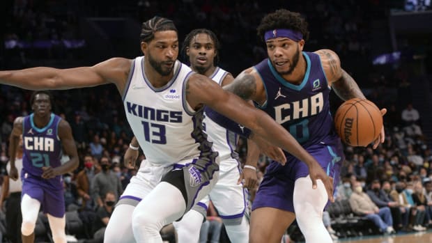 Dec 10, 2021; Charlotte, North Carolina, USA; Charlotte Hornets forward Miles Bridges (0) drives in as he is defended by Sacramento Kings forward Tristian Thompson (13) during the second half at the Spectrum Center. Mandatory Credit: Sam Sharpe-USA TODAY Sports