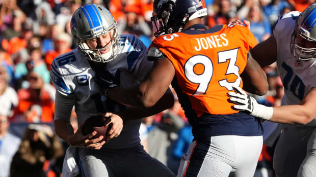 Denver Broncos defensive end Dre'Mont Jones (93) sacks Detroit Lions quarterback Jared Goff (16) in the first quarter at Empower Field at Mile High.