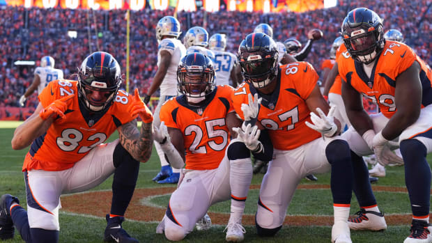 ; Denver Broncos running back Melvin Gordon III (25) celebrates his touchdown carry with teammates tight end Eric Saubert (82) and tight end Noah Fant (87) and Lloyd Cushenberry III (79) in the first quarter against the Detroit Lions at Empower Field at Mile High.