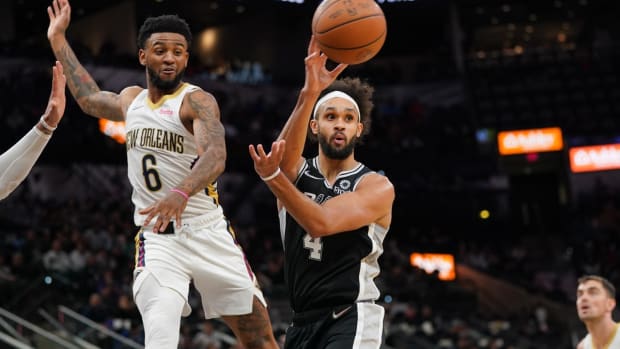 Dec 12, 2021; San Antonio, Texas, USA; San Antonio Spurs guard Derrick White (4) passes in front of New Orleans Pelicans guard Nickeil Alexander-Walker (6) in the second half at the AT&amp;T Center. Mandatory Credit: Daniel Dunn-USA TODAY Sports