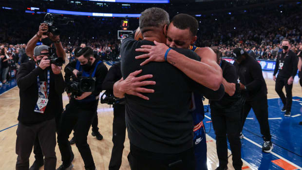 Dec 14, 2021; New York, New York, USA; Golden State Warriors guard Stephen Curry (30) hugs his father Dell Curry (left) after breaking the record for most career three point baskets made during the first half against the New York Knicks at Madison Square Garden.