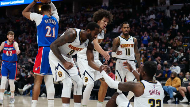 Dec 13, 2021; Denver, Colorado, USA; Denver Nuggets forward Jeff Green (32) and guard Davon Reed (9) and forward Aaron Gordon (50) and guard Monte Morris (11) following a charging foul on the Washington Wizards in the fourth quarter at Ball Arena. Mandatory Credit: Ron Chenoy-USA TODAY Sports