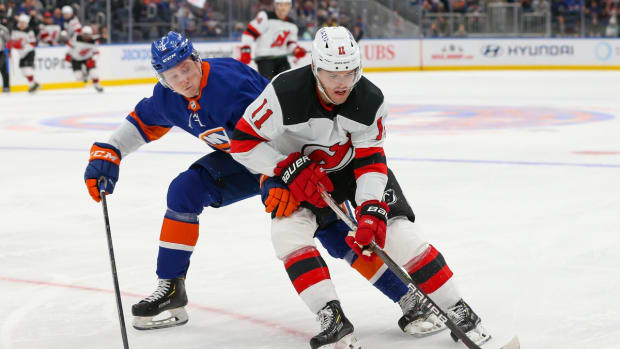 Dec 11, 2021; Elmont, New York, USA; New Jersey Devils left wing Andreas Johnsson (11) skates with the puck past New York Islanders defenseman Robin Salo (2) during the first period at UBS Arena. Mandatory Credit: Tom Horak-USA TODAY Sports