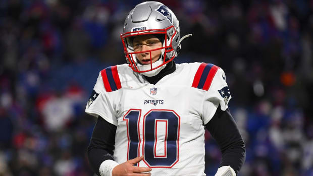 Dec 6, 2021; Orchard Park, New York, USA; New England Patriots quarterback Mac Jones (10) jogs to the sidelines against the Buffalo Bills during the second half at Highmark Stadium. Mandatory Credit: Rich Barnes-USA TODAY Sports