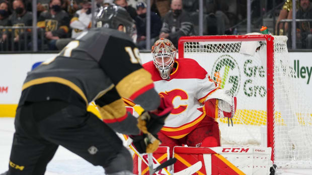 Dec 5, 2021; Las Vegas, Nevada, USA; Calgary Flames goaltender Jacob Markstrom (25) looks to make a save against Vegas Golden Knights right wing Reilly Smith (19) during the second period at T-Mobile Arena. Mandatory Credit: Stephen R. Sylvanie-USA TODAY Sports