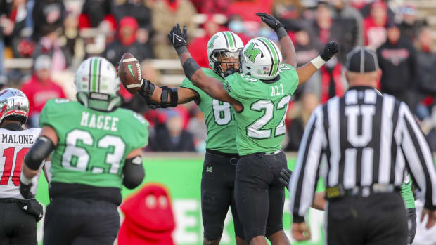 Nov 27, 2021; Huntington, West Virginia, USA; Marshall Thundering Herd tight end Devin Miller (83) celebrates with Marshall Thundering Herd running back Rasheen Ali (22) after catching a touchdown pass during the second quarter against the Western Kentucky Hilltoppers at Joan C. Edwards Stadium. Mandatory Credit: Ben Queen-USA TODAY Sports