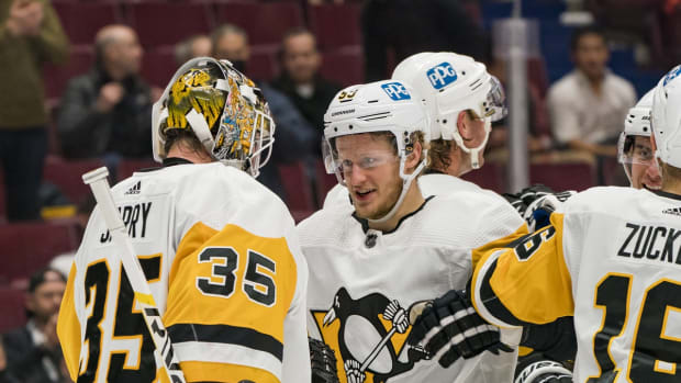 Dec 4, 2021; Vancouver, British Columbia, CAN; Pittsburgh Penguins forward Jake Guentzel (59) and goalie Tristan Jarry (35) celebrate their victory against the Vancouver Canucks at Rogers Arena. Pittsburgh won 4-1. Mandatory Credit: Bob Frid-USA TODAY Sports