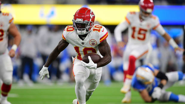 Dec 16, 2021; Inglewood, California, USA; Kansas City Chiefs wide receiver Tyreek Hill (10) runs the ball against the Los Angeles Chargers during the first half at SoFi Stadium. Mandatory Credit: Gary A. Vasquez-USA TODAY Sports