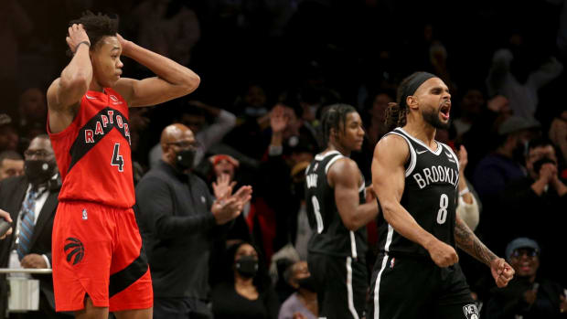 Dec 14, 2021; Brooklyn, New York, USA; Toronto Raptors forward Scottie Barnes (4) and Brooklyn Nets guard Patty Mills (8) react after Barnes misses the potential game-winning shot during overtime at Barclays Center. Mandatory Credit: Brad Penner-USA TODAY Sports