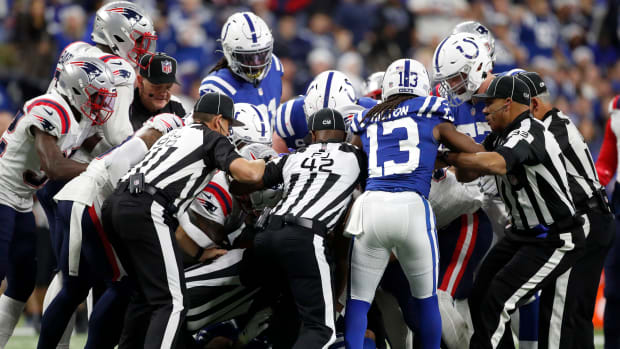 Officials try to break up an altercation between New England Patriots safety Kyle Dugger (23) and Indianapolis Colts wide receiver Michael Pittman Jr. (11) on Saturday, Dec. 18, 2021, during a game against the New England Patriots at Lucas Oil Stadium in Indianapolis.