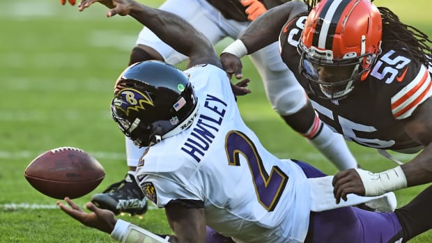 Dec 12, 2021; Cleveland, Ohio, USA; Baltimore Ravens quarterback Tyler Huntley (2) loses the ball from a hit by Cleveland Browns defensive end Takkarist McKinley (55) during the second half at FirstEnergy Stadium. Mandatory Credit: Ken Blaze-USA TODAY Sports