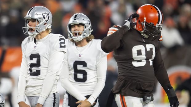 Dec 20, 2021; Cleveland, Ohio, USA; Las Vegas Raiders kicker Daniel Carlson (2) and holder A.J. Cole (6) celebrate after Carlson kicked the game winning field goal as Cleveland Browns defensive tackle Malik Jackson (97) walks off the field during the fourth quarter at FirstEnergy Stadium. Mandatory Credit: Ken Blaze-USA TODAY Sports