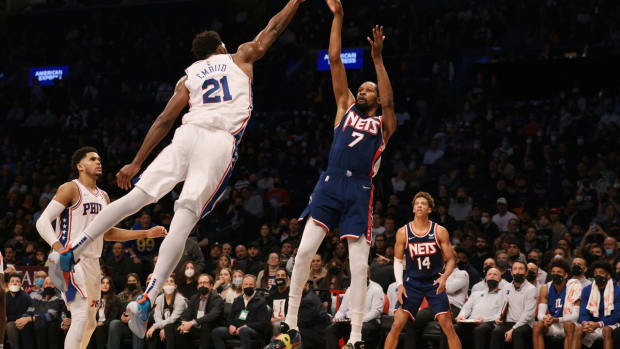 Dec 16, 2021; Brooklyn, New York, USA; Brooklyn Nets forward Kevin Durant (7) shoots the ball as Philadelphia 76ers center Joel Embiid (21) defends during the second half at Barclays Center. Mandatory Credit: Vincent Carchietta-USA TODAY Sports