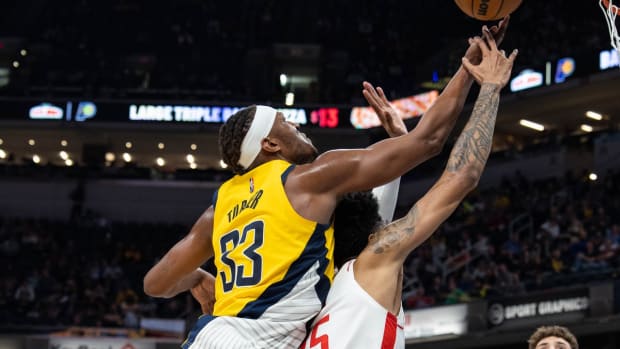 Dec 23, 2021; Indianapolis, Indiana, USA; Indiana Pacers center Myles Turner (33) rebounds the ball over Houston Rockets center Christian Wood (35) in the second half at Gainbridge Fieldhouse. Mandatory Credit: Trevor Ruszkowski-USA TODAY Sports