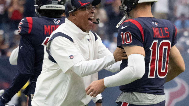 Houston Texans head coach David Culley and quarterback Davis Mills (10) celebrate after a touchdown against the Los Angeles Chargers in the fourth quarter at NRG Stadium.