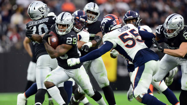 Las Vegas Raiders running back Josh Jacobs (28) runs with the ball against the Denver Broncos during the second half at Allegiant Stadium.