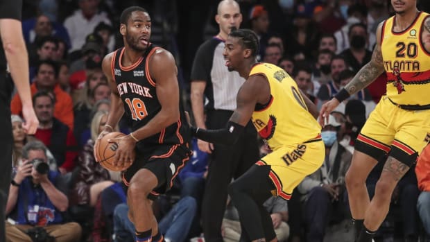 Dec 25, 2021; New York, New York, USA; New York Knicks guard Alec Burks (18) is guarded by Atlanta Hawks guard Delon Wright (0) in the second quarter at Madison Square Garden. Mandatory Credit: Wendell Cruz-USA TODAY Sports