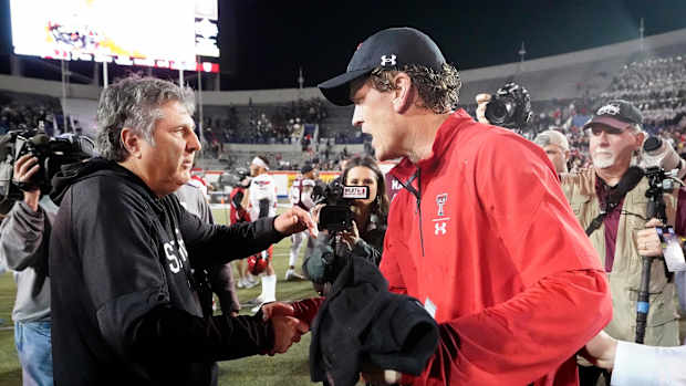 Mississippi State head coach Mike Leach, left, congratulates Texas Tech interim head coach Sonny Cumbie after the Liberty Bowl NCAA college football game Tuesday, Dec. 28, 2021, in Memphis, Tenn. Texas Tech won 34-7.