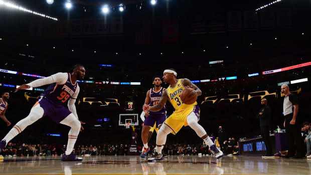 Dec 21, 2021; Los Angeles, California, USA; Los Angeles Lakers guard Isaiah Thomas (31) moves the ball against Phoenix Suns forward Jae Crowder (99) during the first half at Staples Center.