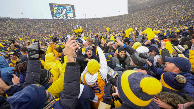 Michigan fans flood the field after the Wolverines beat Ohio State