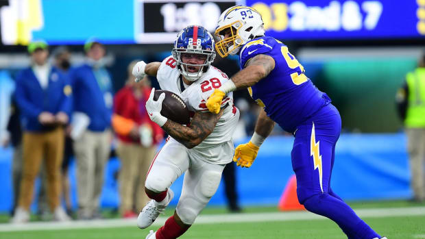 Dec 12, 2021; Inglewood, California, USA; New York Giants running back Devontae Booker (28) runs the ball against Los Angeles Chargers defensive tackle Justin Jones (93) during the second half at SoFi Stadium. Mandatory Credit: Gary A. Vasquez-USA TODAY Sports