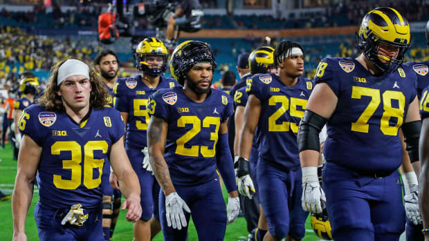 Michigan players dejectedly walk off the field after the loss to Georgia