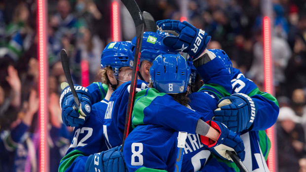 Dec 14, 2021; Vancouver, British Columbia, CAN; Vancouver Canucks forward Elias Pettersson (40) and forward Conor Garland (8) celebrate Pettersson s goal against the Columbus Blue Jackets in the third period at Rogers Arena. Vancouver Won 4-3.