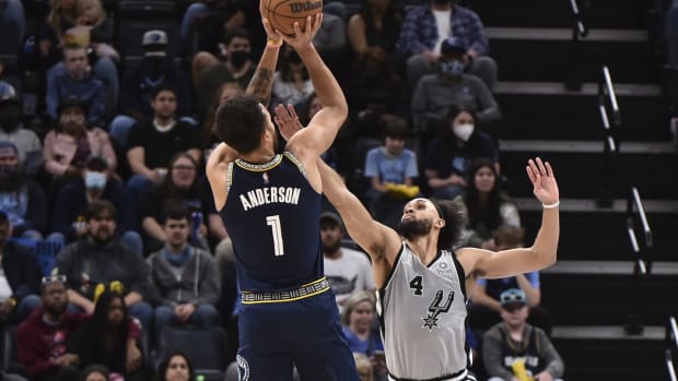 Dec 31, 2021; Memphis, Tennessee, USA; Memphis Grizzlies guard Tyrell Terry (1) shoots the ball over San Antonio Spurs guard Derrick White (4) during the first half at FedExForum. Mandatory Credit: Justin Ford-USA TODAY Sports