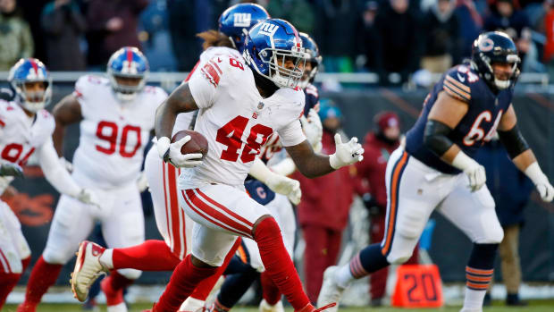 Jan 2, 2022; Chicago, Illinois, USA; New York Giants inside linebacker Tae Crowder (48) runs with the ball after making an interception against the Chicago Bears during the second half at Soldier Field.